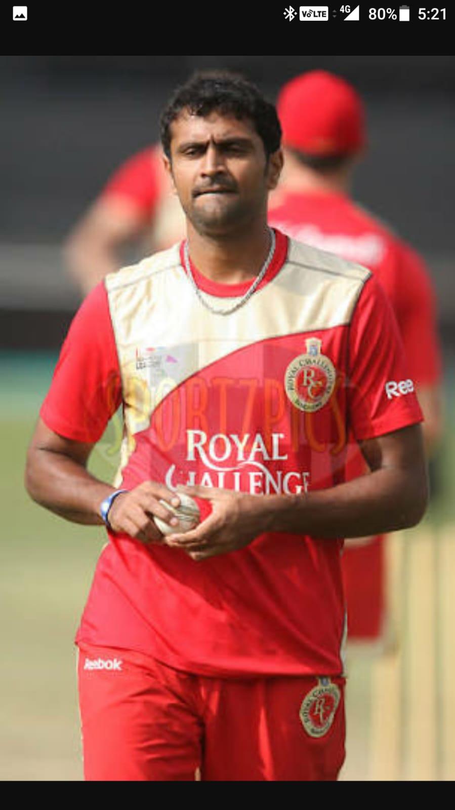 Akhil in RCB jersey with ball